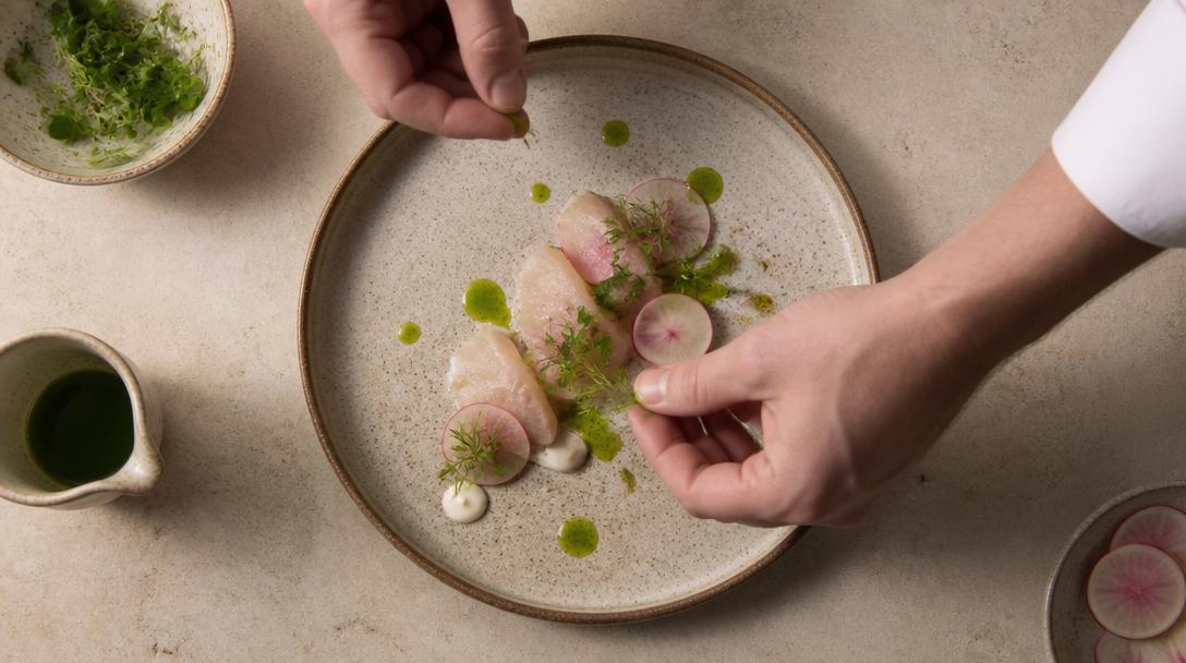 Chef plating a dish for the monthly club challenge